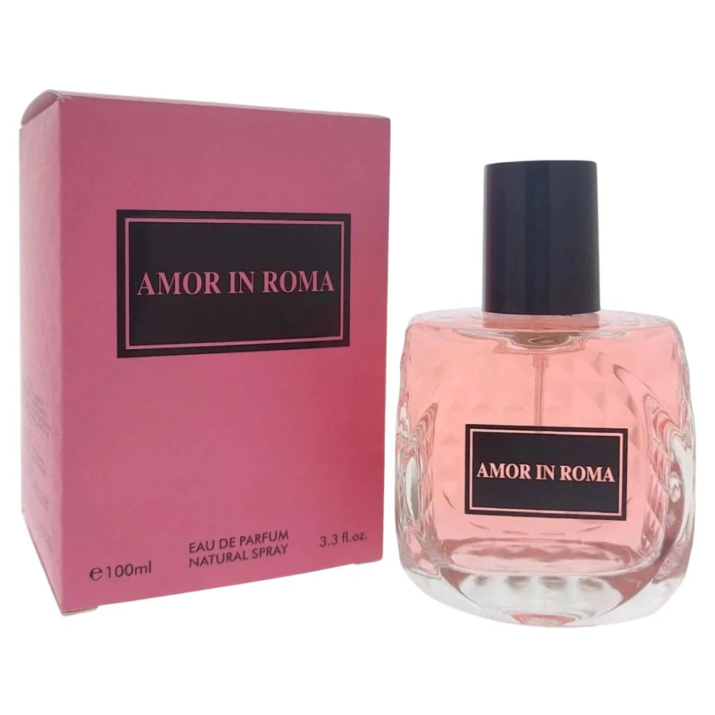 Amor in Roma 100ml Eau de Parfum in a pink-tinted round glass bottle next to its matching pink and black box.