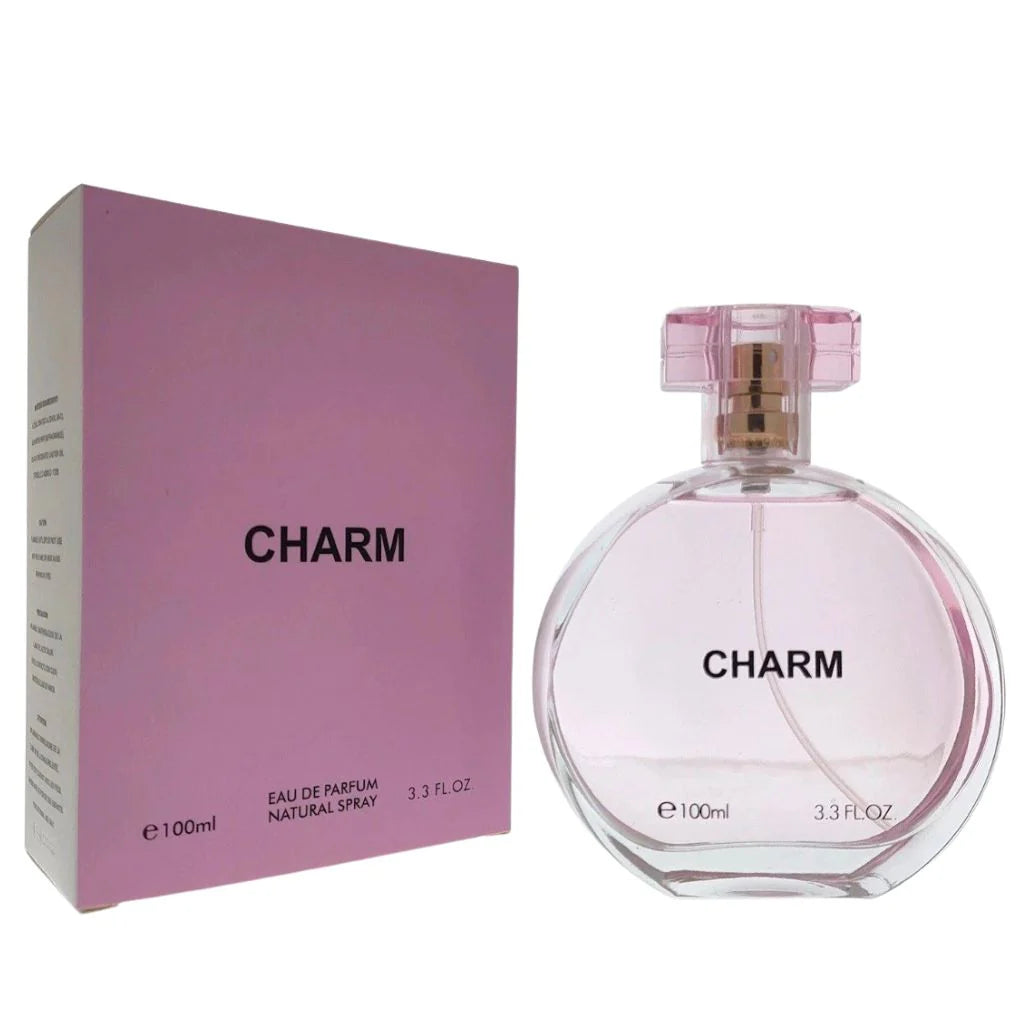 Charm 100ml Eau de Parfum in a clear rounded bottle with a pink cap next to its minimalist pink retail box.
