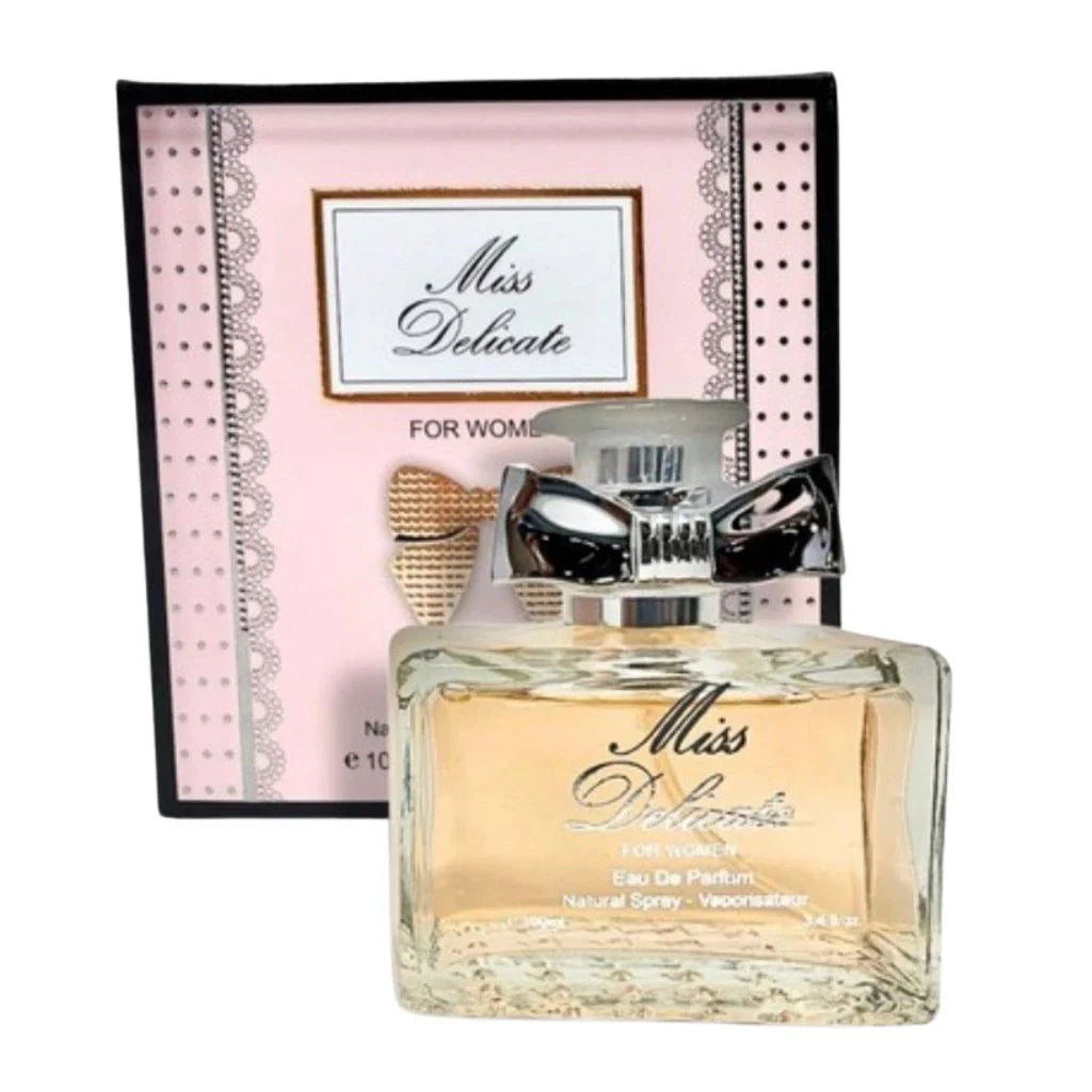 Miss Delicate 100ml Eau de Parfum in a clear glass bottle with a silver bow accent next to its elegant pink and white patterned box.
