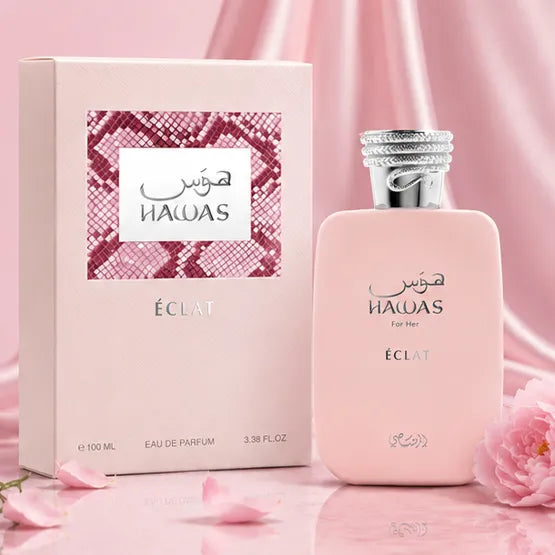 Rasasi Hawas Eclat for Women Eau De Parfum 100ml pink bottle next to its luxury blush pink and snakeskin pattern retail box 2