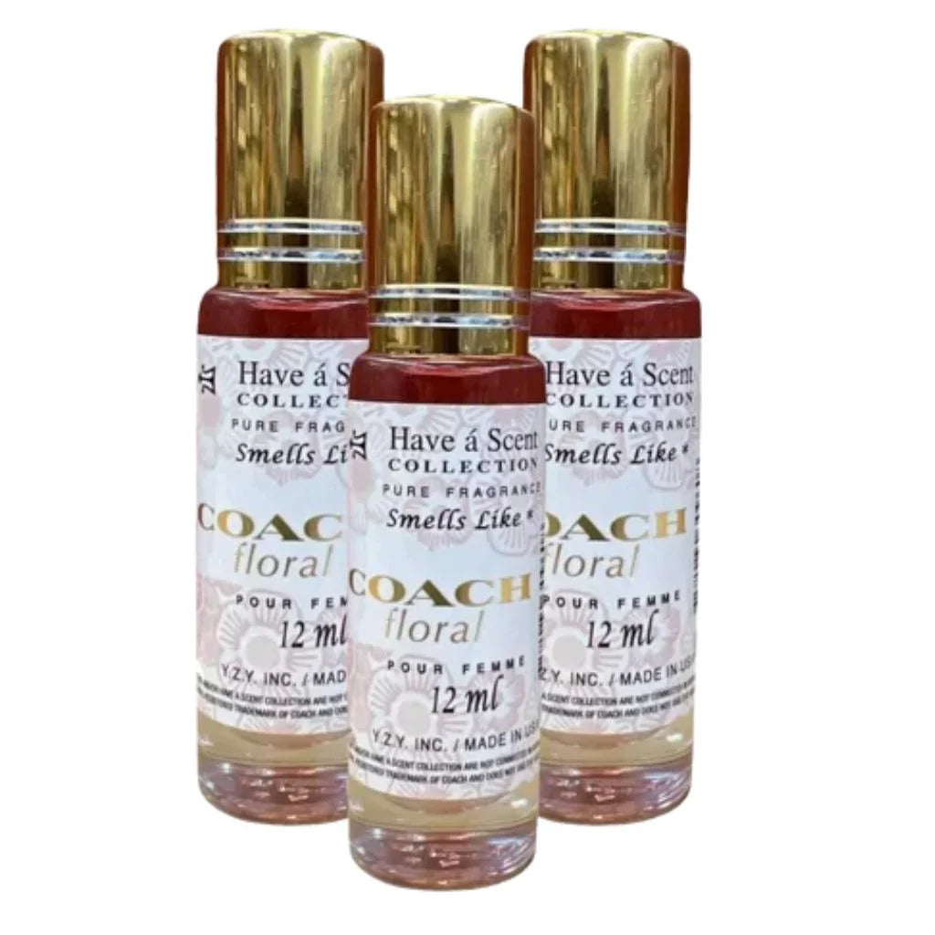Three gold capped twelve milliliter rollerball bottles of Ch Floral pure concentrated perfume oil for women arranged together